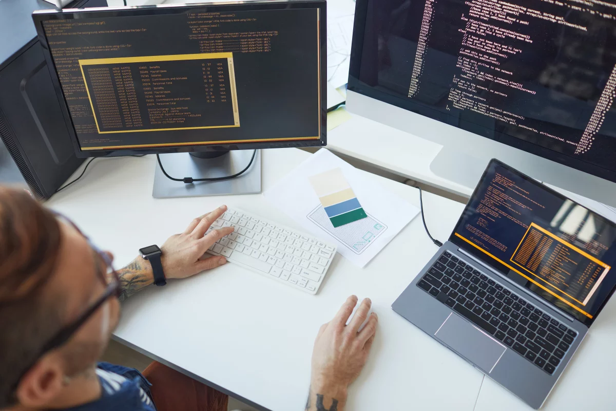 Ruka na klávesnici laptopu programuje